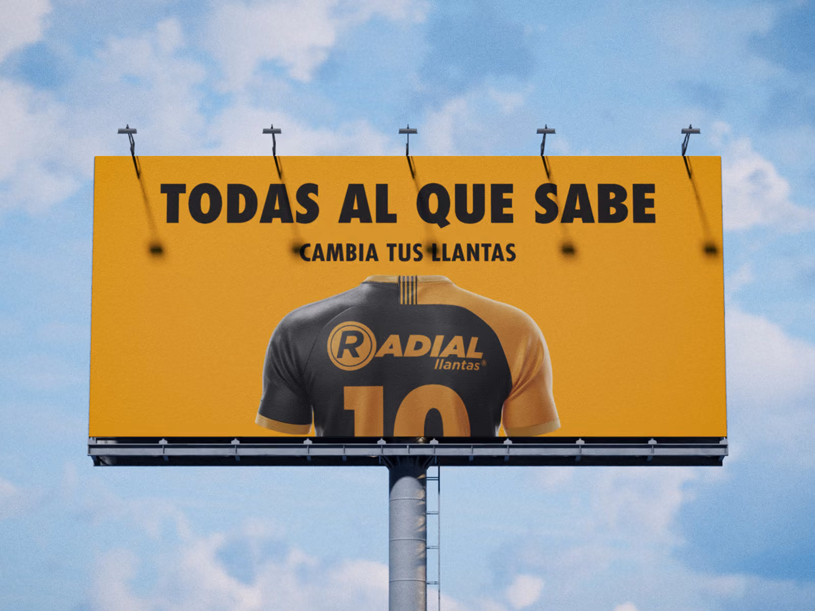 Cartel publicitario amarillo que dice cambia tus llantas con una camiseta deportiva sin cabeza.